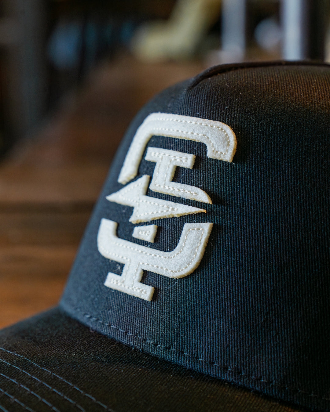 Black cap with a white logo on a blurred background