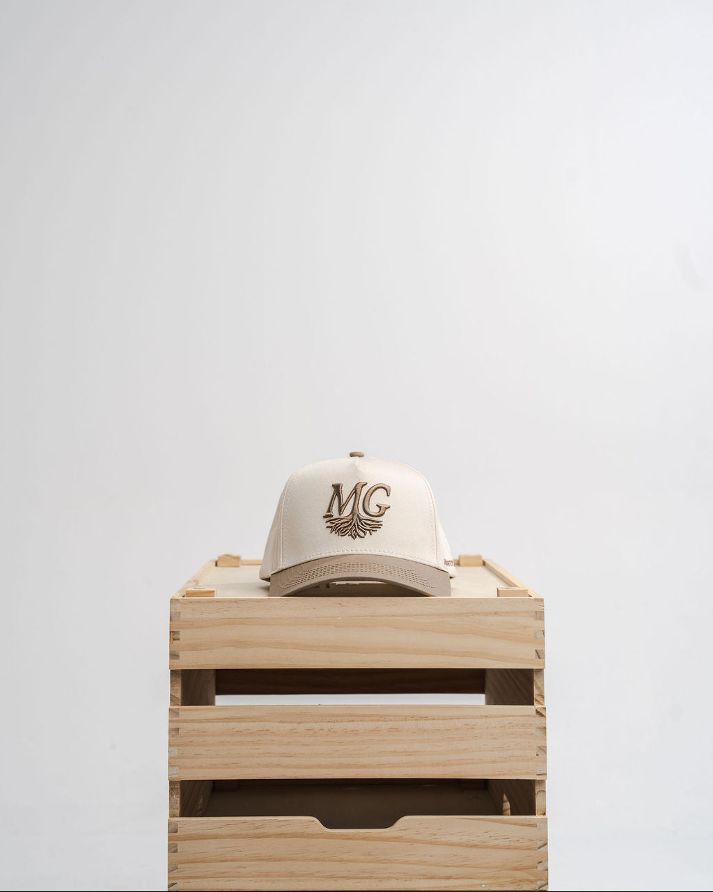 White cap with 'Midwest Grown' logo on a wooden crate against a white background